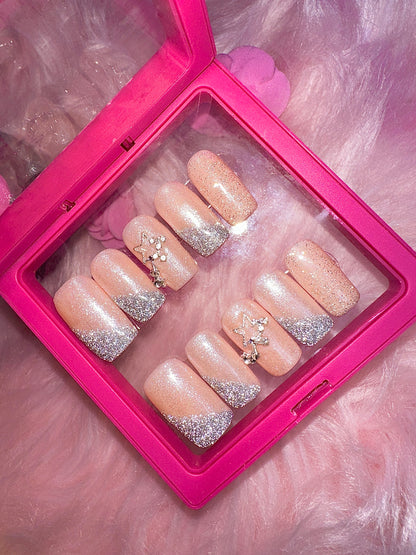 Nude square nails with reflective glitter.