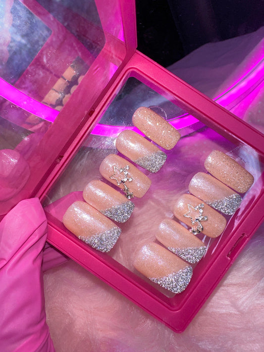 Nude square nails with reflective glitter.